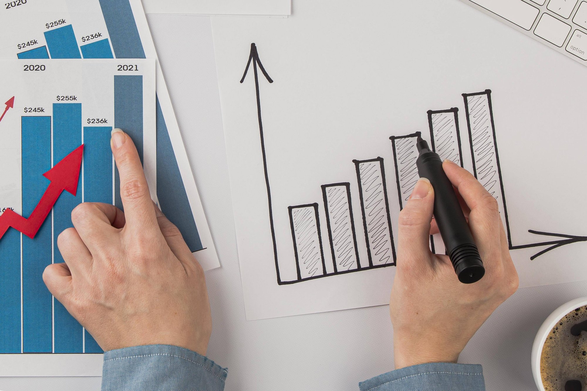 top-view-office-desk-with-growth-chart-hands